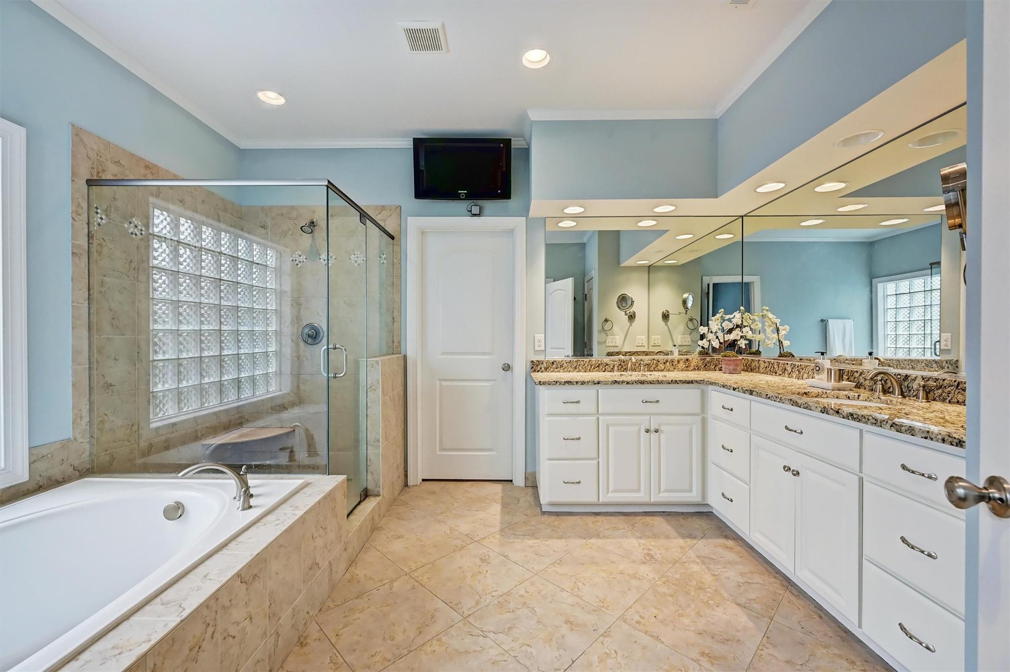 6009 Sharon View Road Charlotte, NC 28226 - Photo 32 of 47 a spacious bathroom with a double vanity sink a mirror and a bathtub