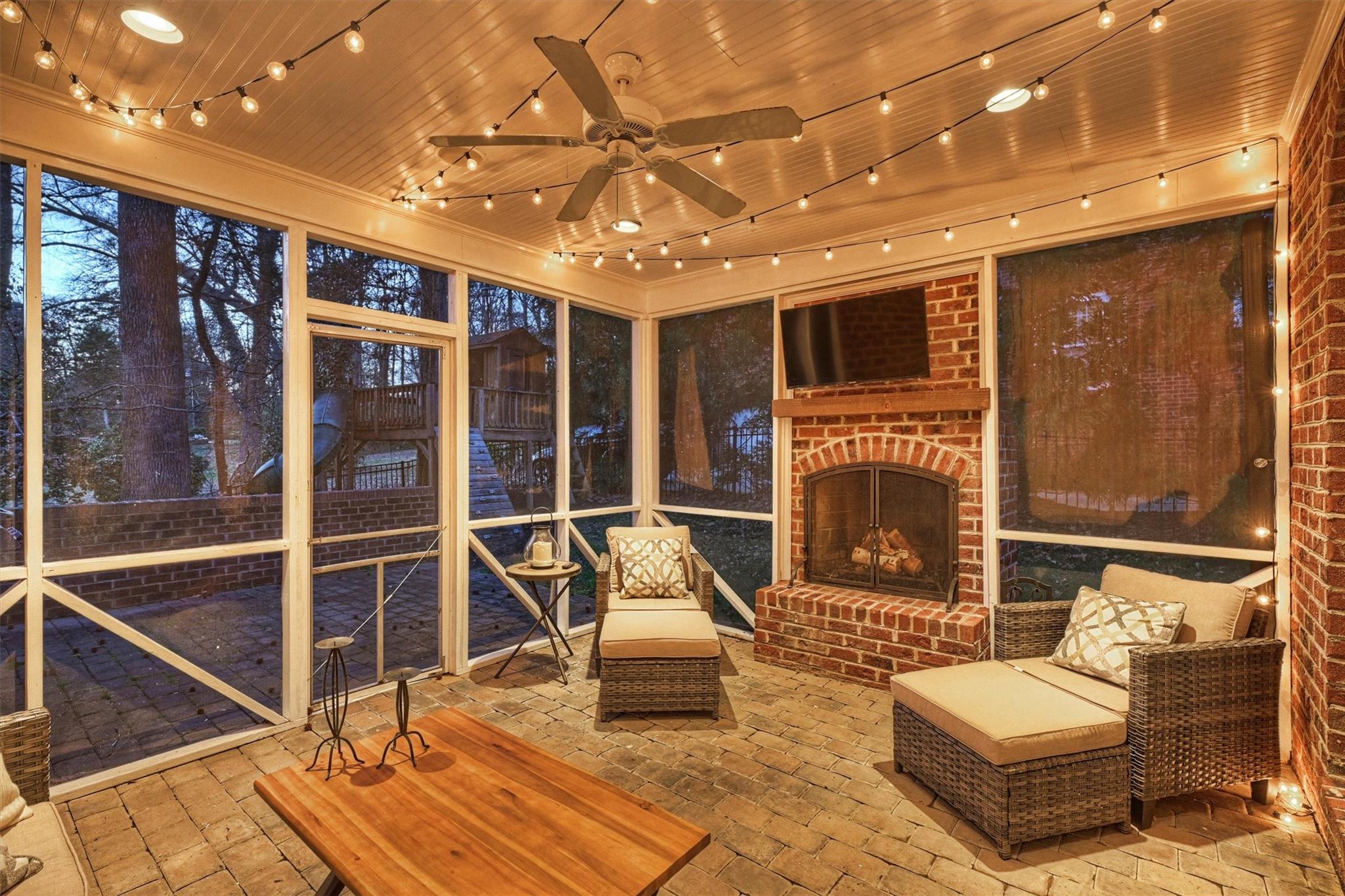 6009 Sharon View Road Charlotte, NC 28226 - Photo 39 of 47 a living room with furniture a fireplace and a flat screen tv