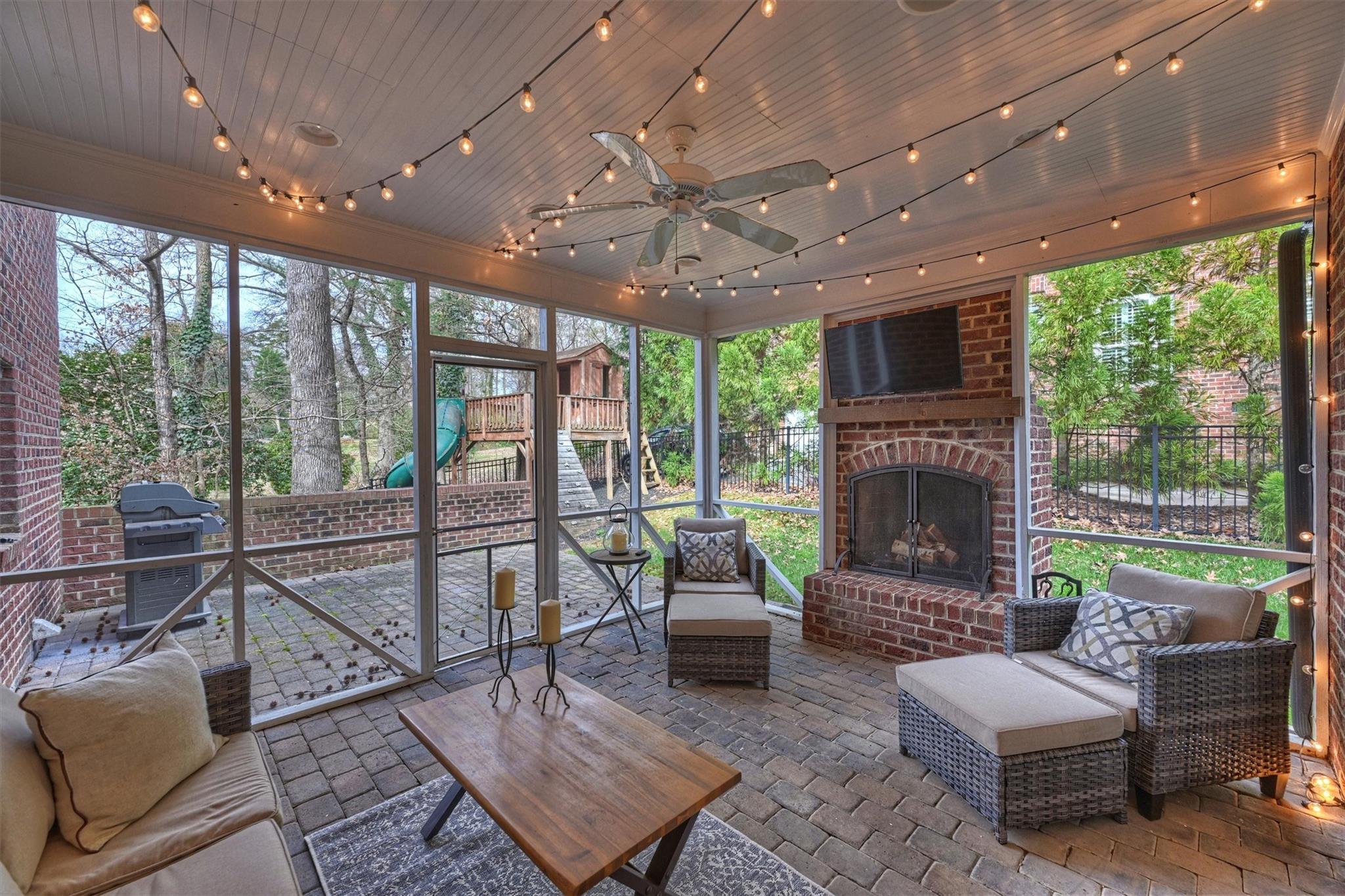 6009 Sharon View Road Charlotte, NC 28226 - Photo 45 of 47 a living room with furniture a fireplace and a floor to ceiling window
