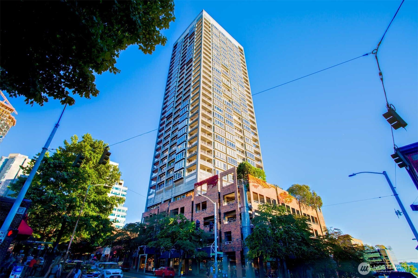 a front view of a multi story building with yard