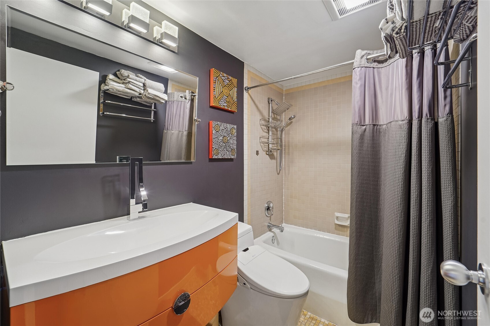 2125 1st Avenue, Unit 1702 Seattle, WA 98121 - Photo 14 of 26 a bathroom with a sink a toilet and shower