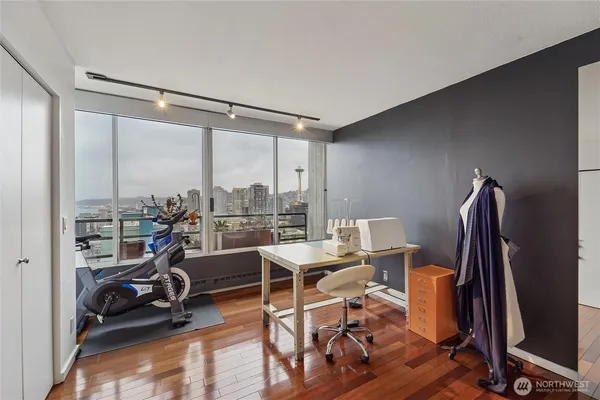 a view of a workspace with furniture and floor to ceiling window