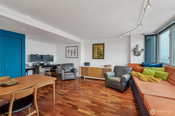 a living room with furniture a rug and a lamp