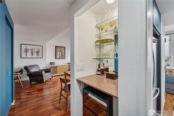 a view of a workspace with furniture window and wooden floor