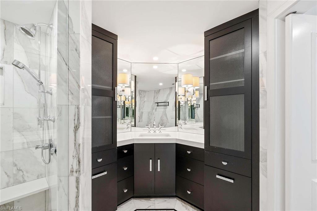 1325 7th Street South, Unit 2B Naples, FL 34102 - Photo 16 of 34 a bathroom with a granite countertop sink a toilet and shower