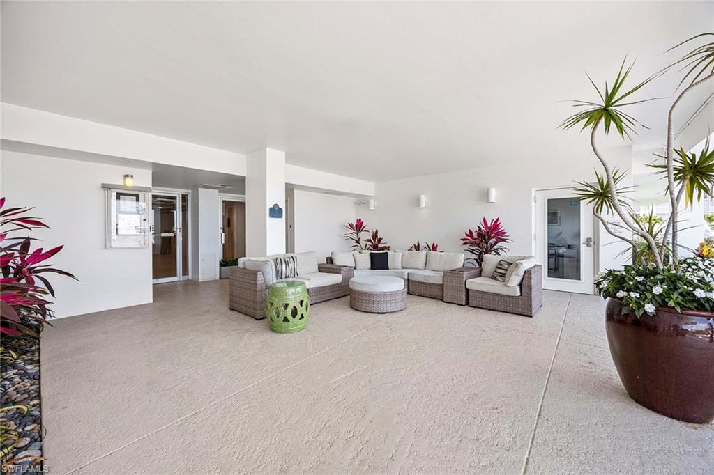 1325 7th Street South, Unit 2B Naples, FL 34102 - Photo 23 of 34 a living room with furniture and potted plants