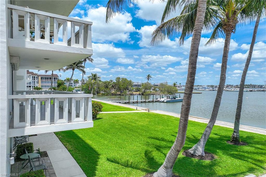 1325 7th Street South, Unit 2B Naples, FL 34102 - Photo 5 of 34 a view of a swimming pool with a garden