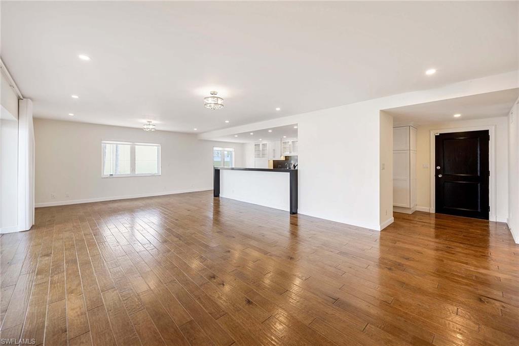 1325 7th Street South, Unit 2B Naples, FL 34102 - Photo 9 of 34 a view of an empty room with wooden floor and a window