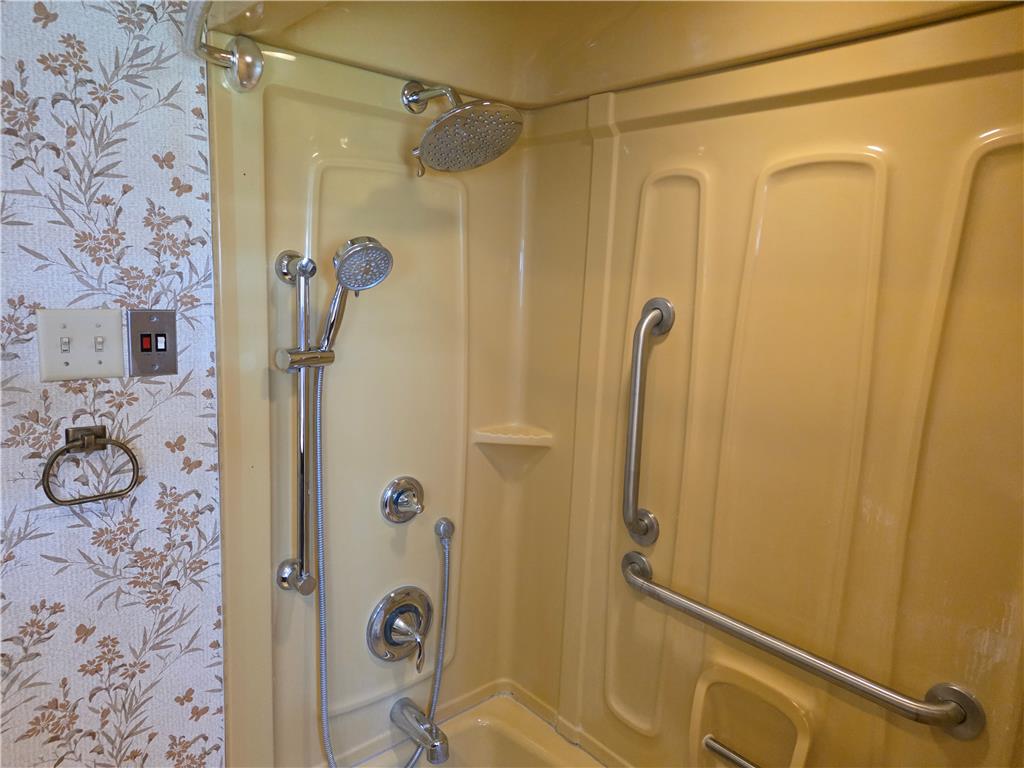 3134 Roxford Road Allentown, PA 18103 - Photo 31 of 34 Accessible features enhance this shower, offering both a fixed and handheld showerhead for comfort and convenience.