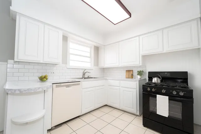 a kitchen with white cabinets sink and white appliances