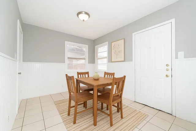 a view of a dining room with furniture and a window