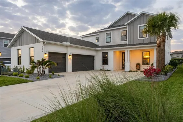 a front view of house with yard and green space