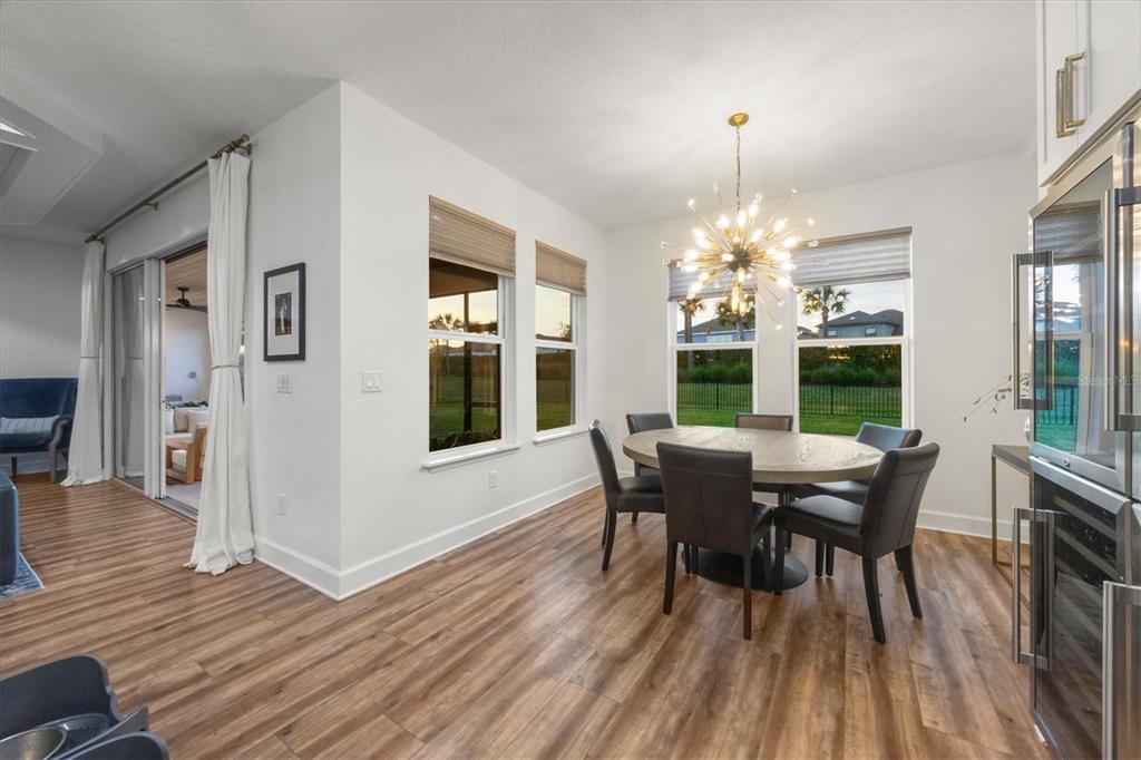 8498 Snowfall Street Sarasota, FL 34241 - Photo 23 of 95 a view of a dining room with furniture window and wooden floor