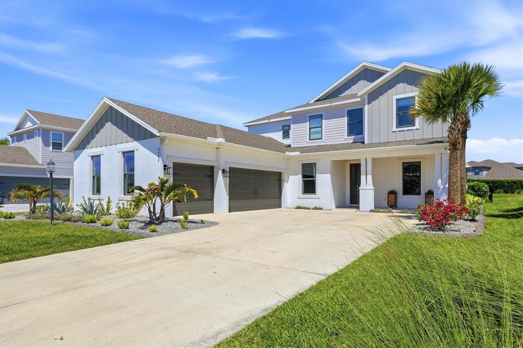 8498 Snowfall Street Sarasota, FL 34241 - Photo 3 of 95 a front view of a house with a yard
