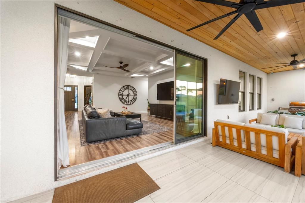 8498 Snowfall Street Sarasota, FL 34241 - Photo 32 of 95 a living room with furniture and a flat screen tv