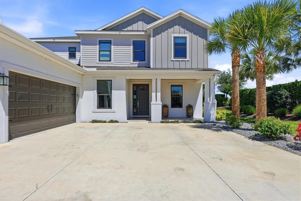 8498 Snowfall Street Sarasota, FL 34241 - Photo 4 of 95 a front view of a house with a yard and garage