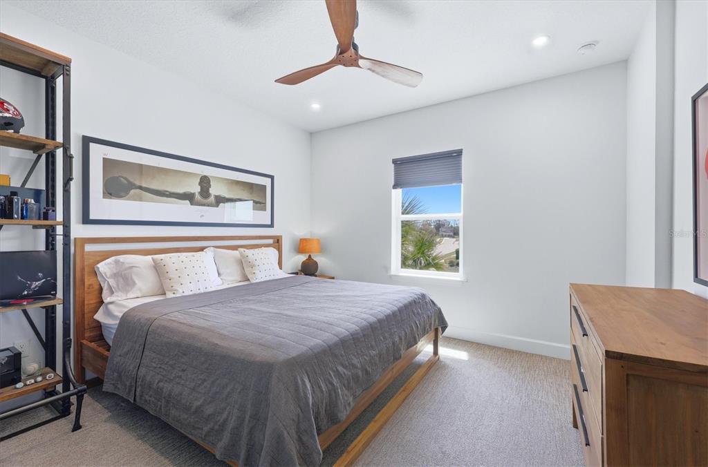 8498 Snowfall Street Sarasota, FL 34241 - Photo 47 of 95 a bedroom with a bed and a chandelier