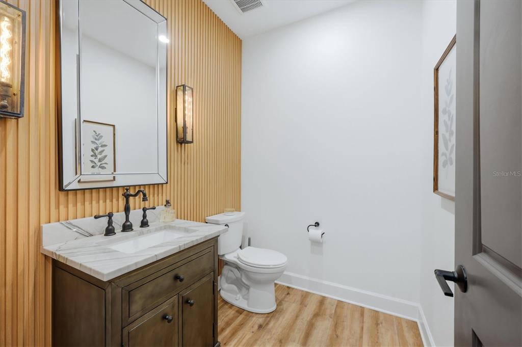 8498 Snowfall Street Sarasota, FL 34241 - Photo 54 of 95 a bathroom with a granite countertop sink toilet and mirror