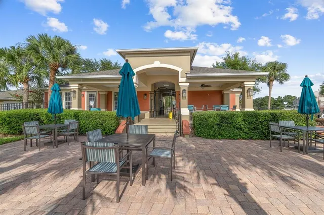 a view of a house with a chairs and table in a patio