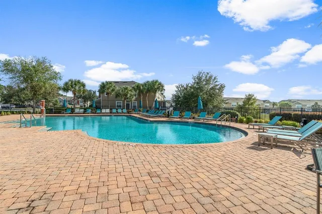 a view of swimming pool with a yard and lake view