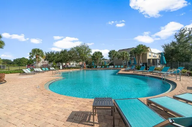 a view of a swimming pool and lounge chairs