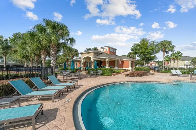 a view of a house with swimming pool and sitting area