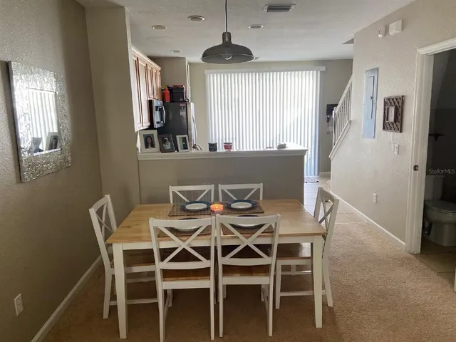 a view of a dining room with furniture and window