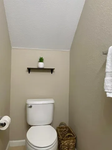 a white toilet sitting next to a shower