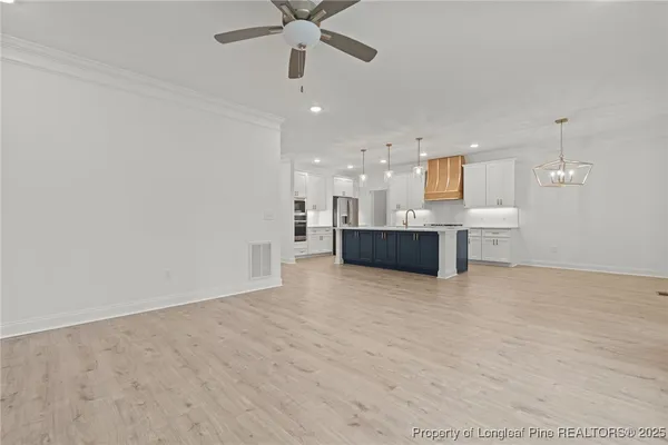 an empty room with a kitchen and a sink