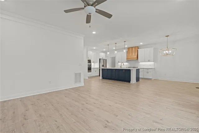 an empty room with a kitchen and a sink