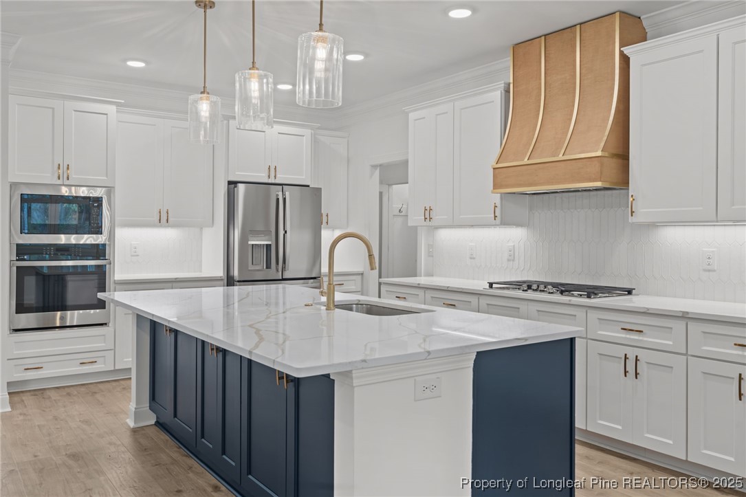 45 Pine Hill Court Spring Lake, NC 28390 - Photo 13 of 40 a kitchen with stainless steel appliances granite countertop a sink a stove and a refrigerator