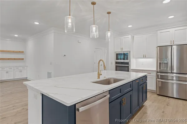 a stove top oven sitting inside of a kitchen