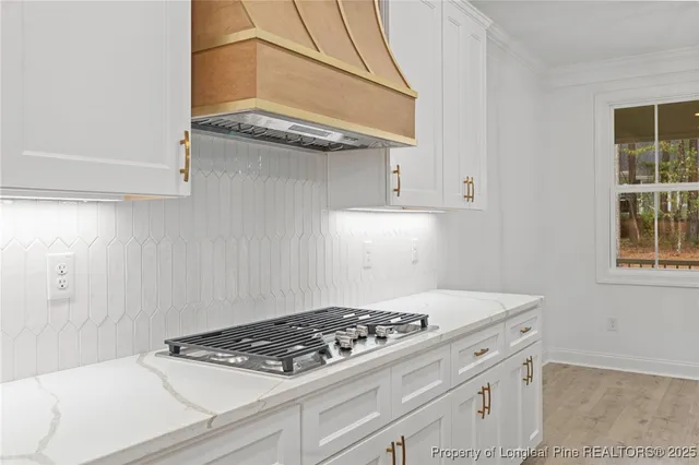 a kitchen with stainless steel appliances granite countertop a refrigerator and a stove top oven