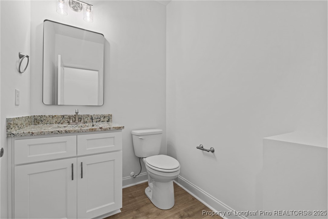 45 Pine Hill Court Spring Lake, NC 28390 - Photo 19 of 40 a bathroom with a toilet a sink and a mirror