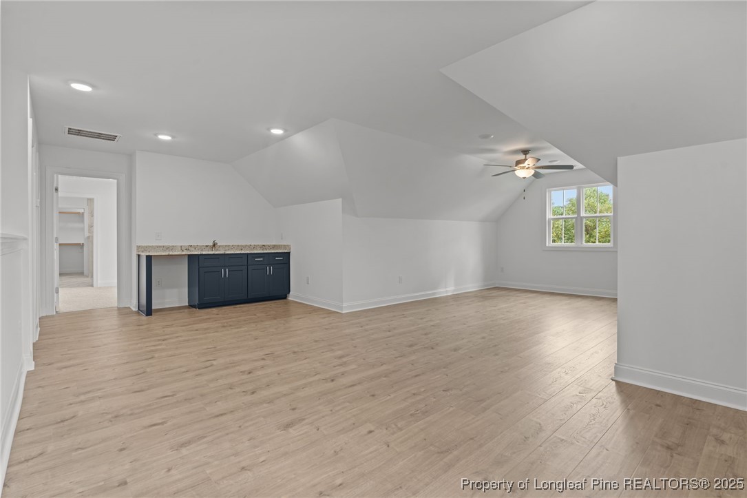45 Pine Hill Court Spring Lake, NC 28390 - Photo 25 of 40 an empty room with wooden floor and windows