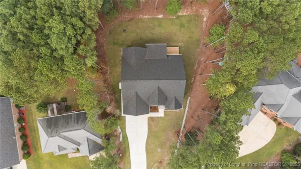 an aerial view of a house with a yard