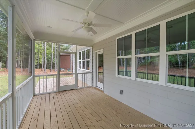a view of backyard with large trees and wooden fence