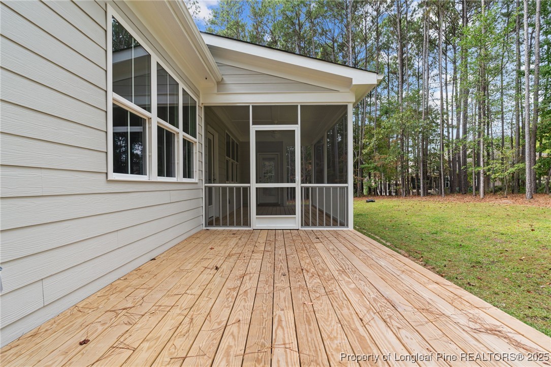 45 Pine Hill Court Spring Lake, NC 28390 - Photo 36 of 40 a view of backyard with large trees and wooden fence
