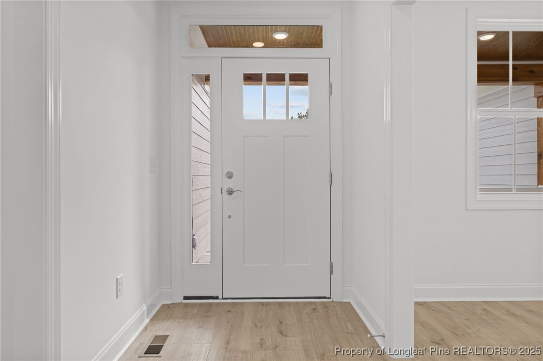 45 Pine Hill Court Spring Lake, NC 28390 - Photo 4 of 40 an empty room with wooden floor and windows