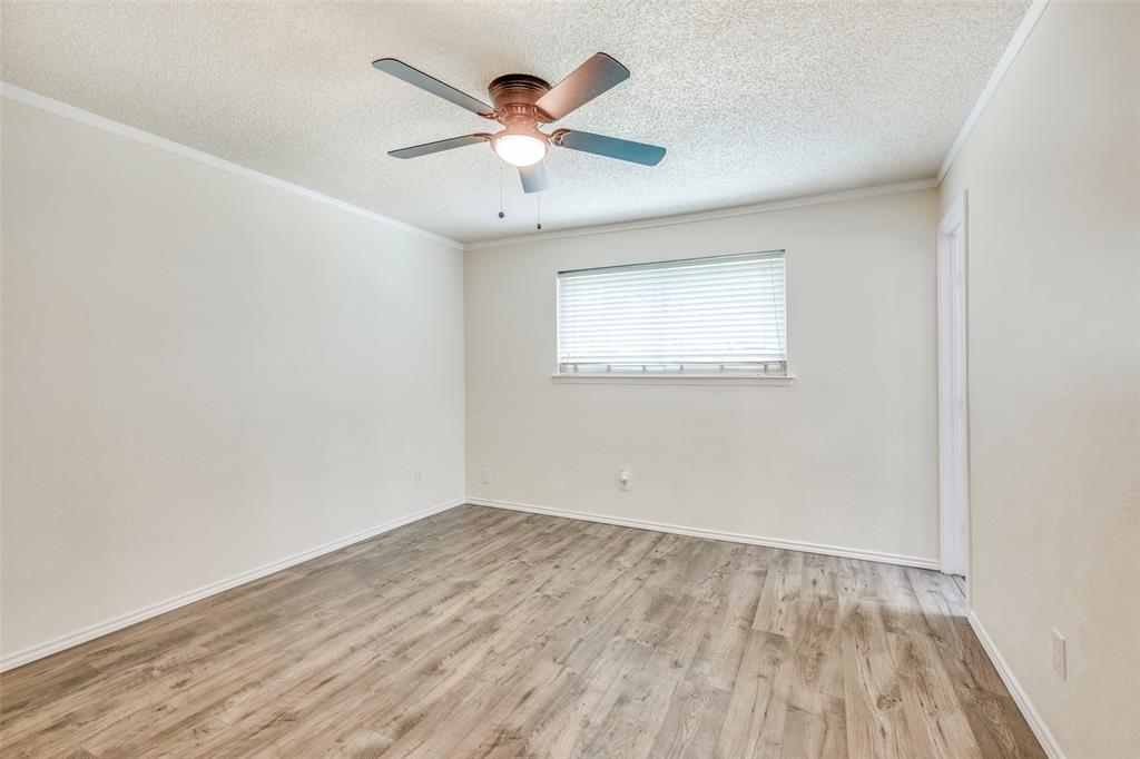 5901 Myers Road Arlington, TX 76017 - Photo 12 of 23 an empty room with wooden floor and windows