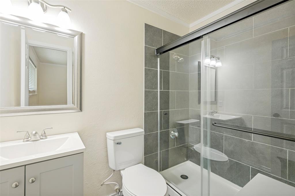 5901 Myers Road Arlington, TX 76017 - Photo 13 of 23 a bathroom with a toilet a sink and shower