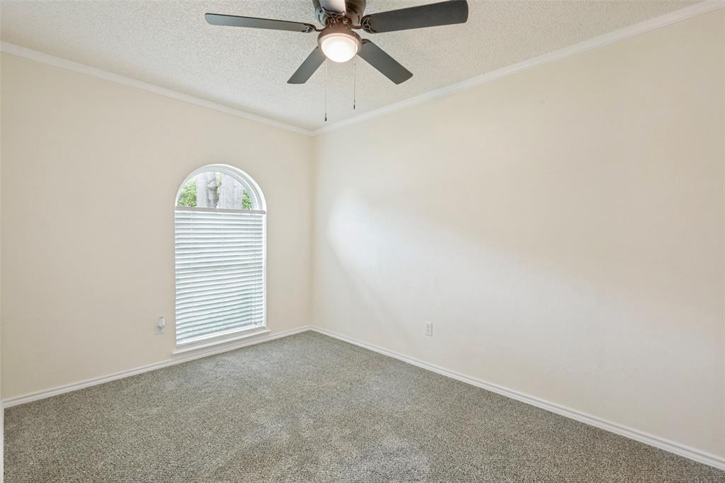 5901 Myers Road Arlington, TX 76017 - Photo 14 of 23 an empty room with a window and a fan