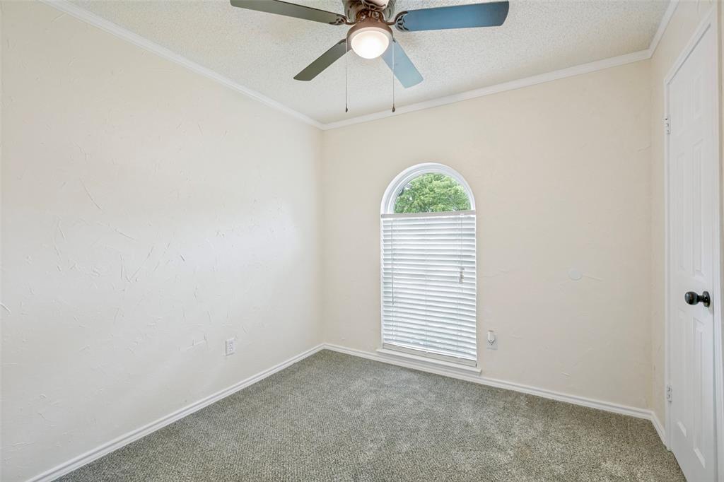 5901 Myers Road Arlington, TX 76017 - Photo 16 of 23 an empty room with a window and a fan