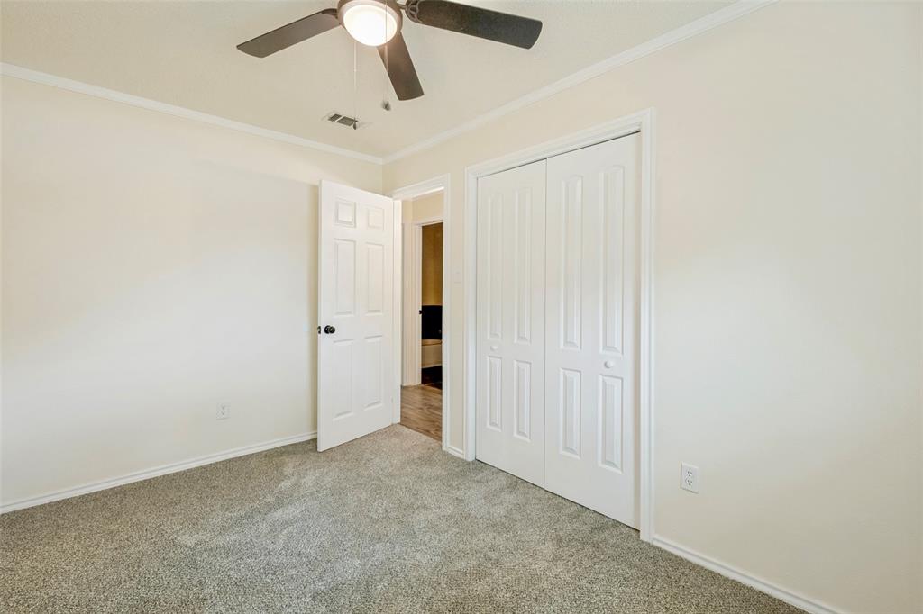 5901 Myers Road Arlington, TX 76017 - Photo 17 of 23 an empty room with a ceiling fan and carpet