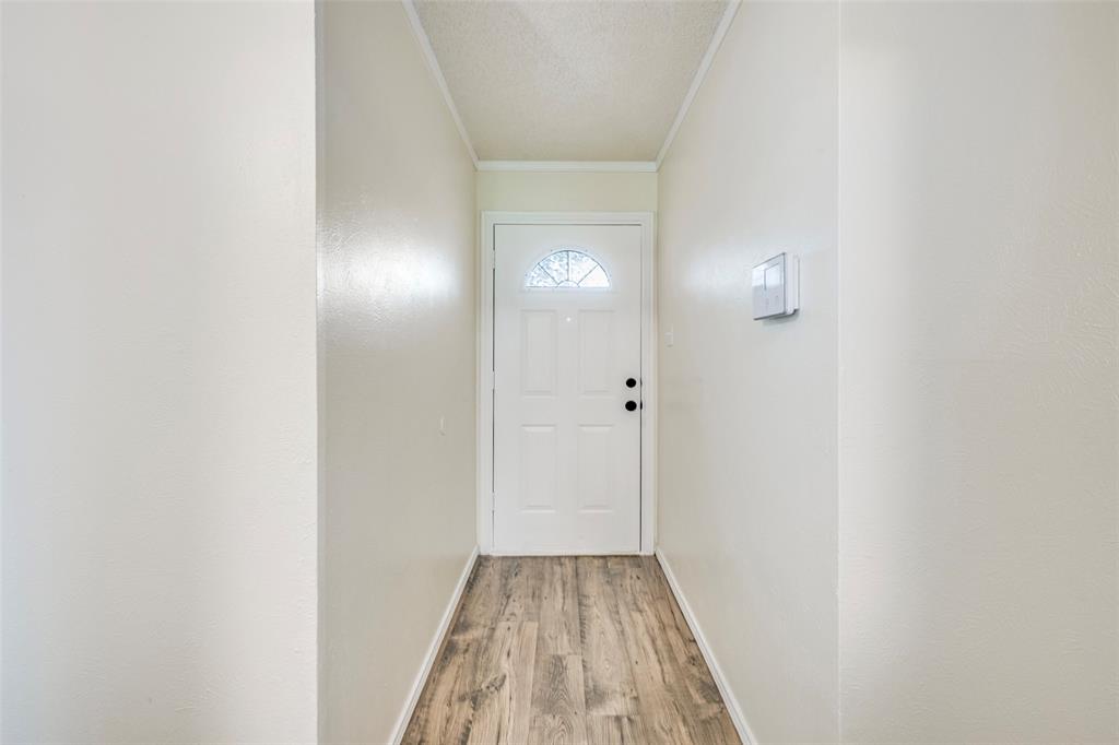 5901 Myers Road Arlington, TX 76017 - Photo 19 of 23 a view of a hallway with wooden floor