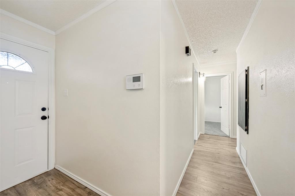 5901 Myers Road Arlington, TX 76017 - Photo 20 of 23 a view of a hallway with wooden floor