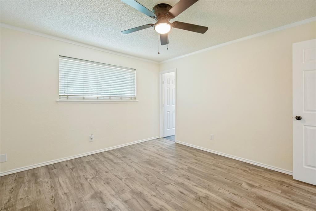 5901 Myers Road Arlington, TX 76017 - Photo 10 of 23 an empty room with a window and a ceiling fan