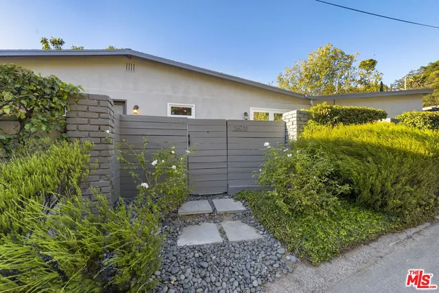 a view of a hallway with a window and a bathroom