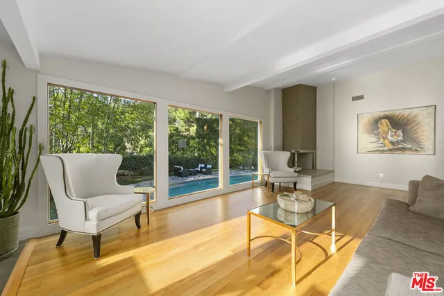 a living room with furniture and a floor to ceiling window