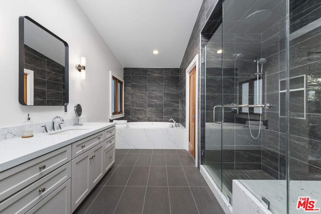2601 Nichols Canyon Road Los Angeles, CA 90046 - Photo 11 of 28 a bathroom with a double vanity sink a large mirror and shower